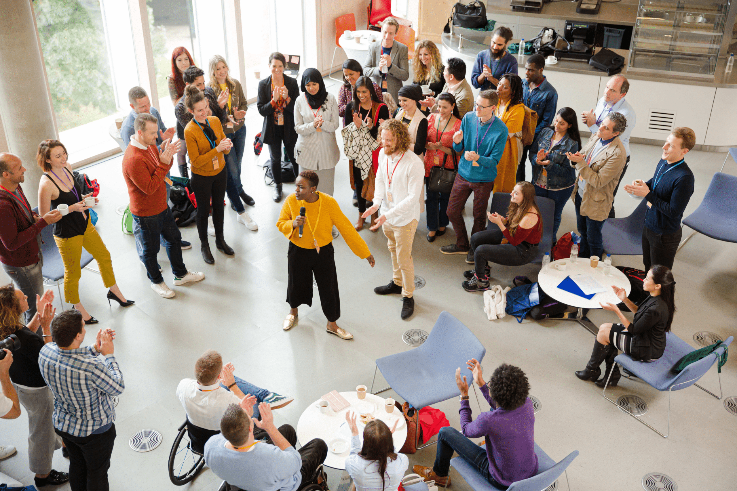 group of people gathered around a workshop speaker